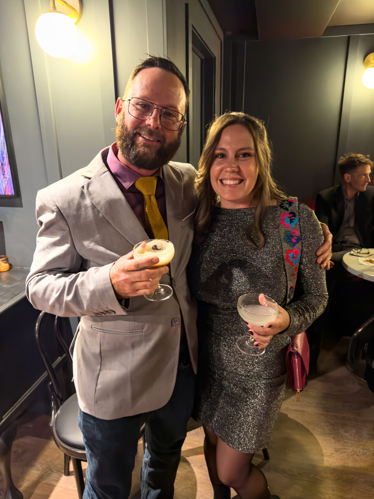 Guests smiling with drinks at a previous First Pour event