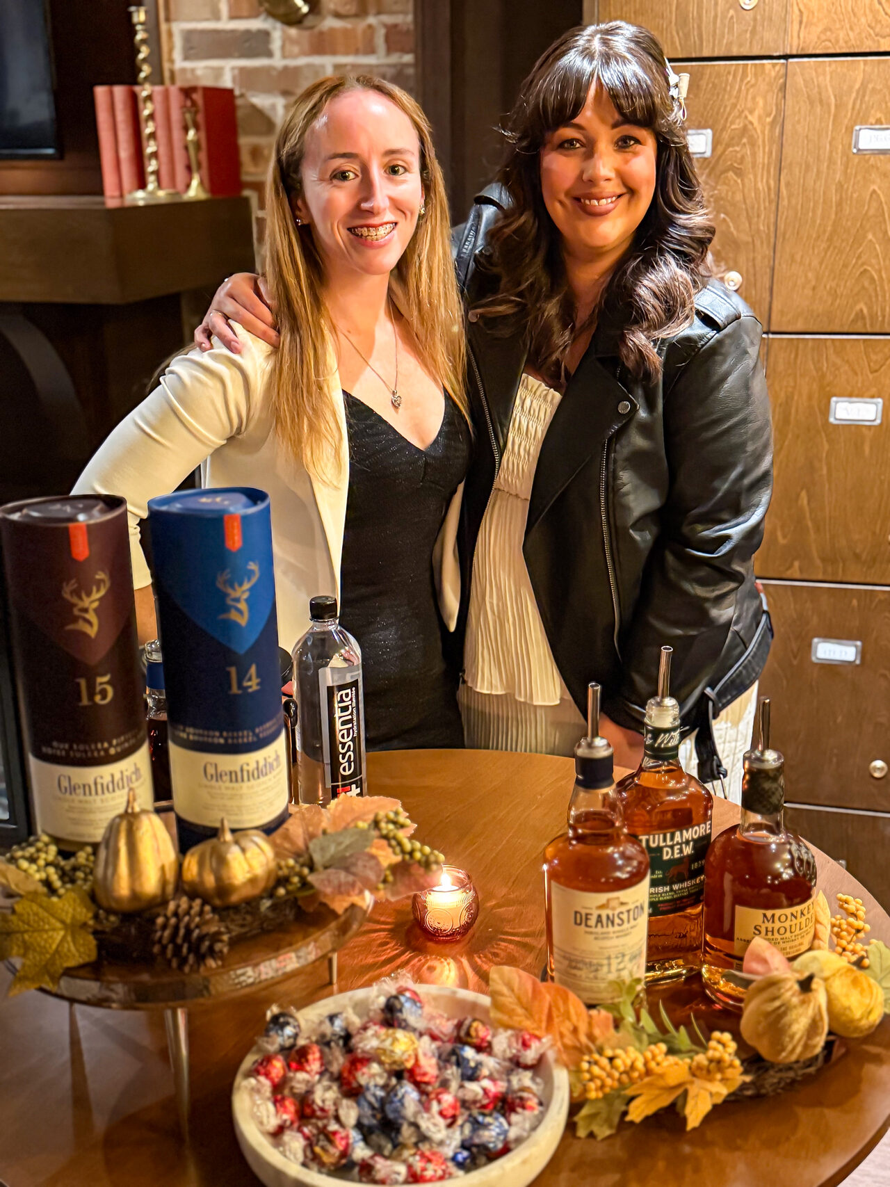 Hosts presenting drinks and food pairings at a First Pour table