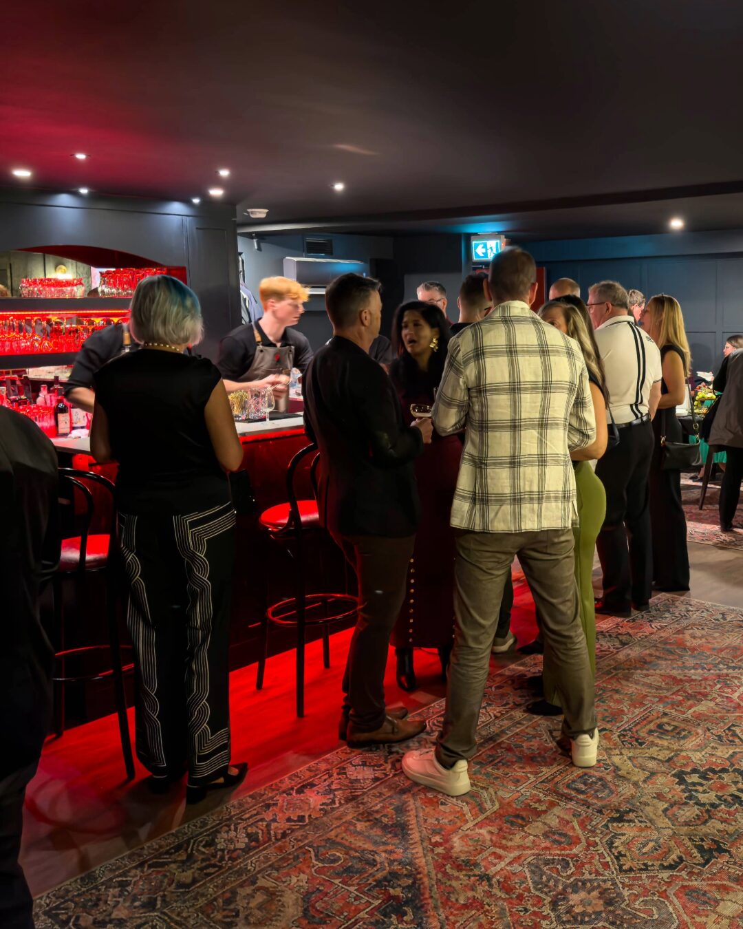 Guests gathered in a warm event room during a previous First Pour