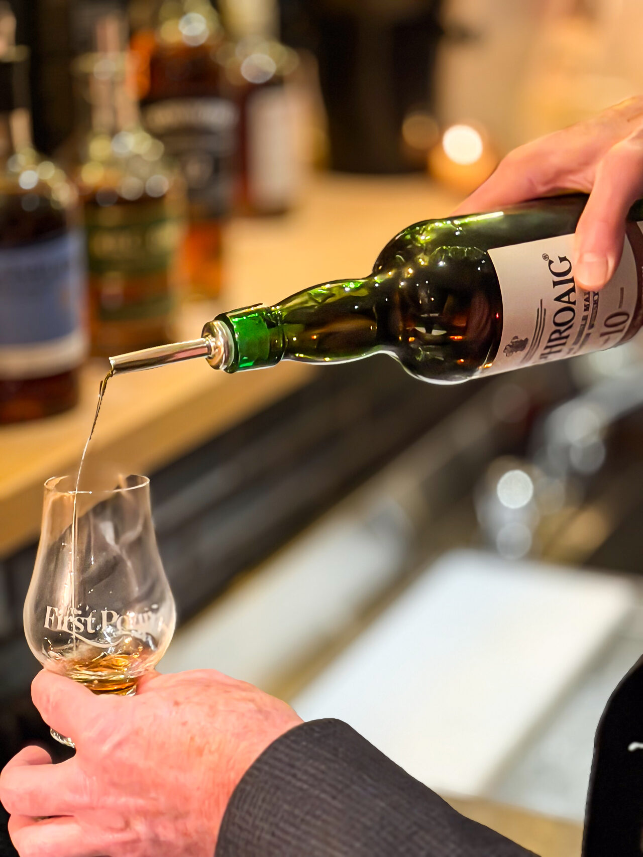 Wine being poured into a glass during a First Pour tasting